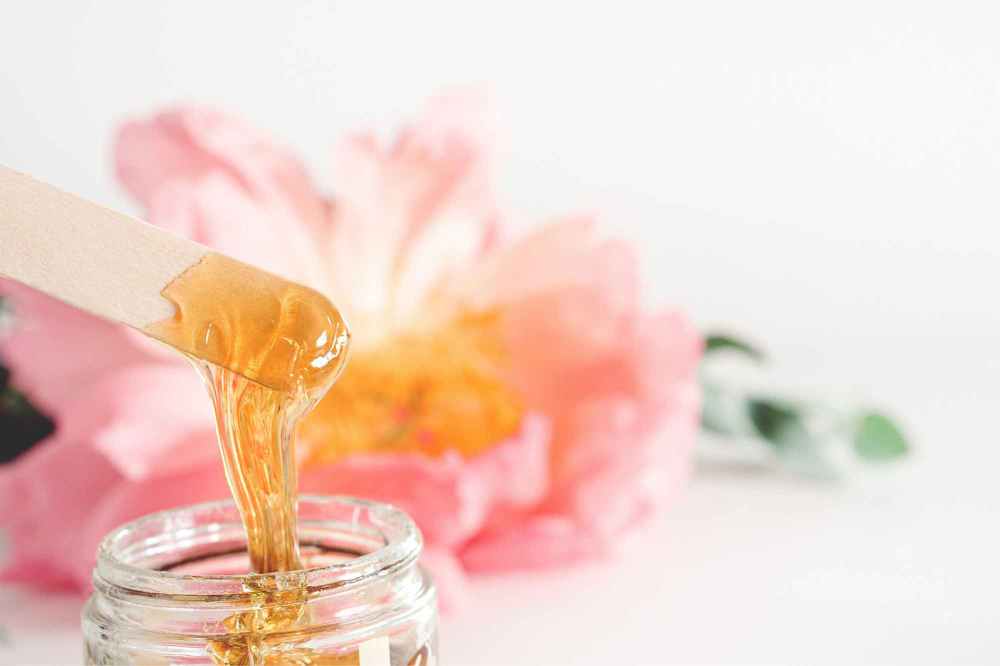 Pot of hair removal wax for beauty treatment